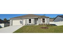 Nice two-bedroom house with a white garage door and green lawn at 1412 Swan Ct, Poinciana, FL 34759