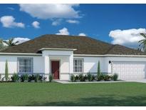 Newly built home with a gray roof, attached garage and a well-maintained lawn at 3863 Sw 110Th St, Ocala, FL 34476