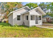 Charming bungalow exterior with a covered porch and well-maintained lawn at 4251 Tangerine Ave, Sanford, FL 32773
