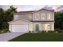 Two-story house with a large garage and well-manicured lawn at 1705 Seabass Ln, Poinciana, FL 34759