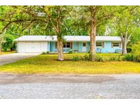 Ranch style home with two car garage and mature landscaping at 6269 Se 125Th Pl, Belleview, FL 34420