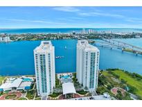 Aerial view of two waterfront condo buildings with a pool and marina at 231 Riverside Dr # 2409-1, Holly Hill, FL 32117