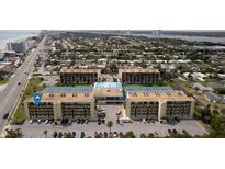 Aerial view of condo complex with tennis courts and pool at 1433 N Atlantic Ave # 422, Daytona Beach, FL 32118