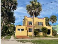 Two-story home with stucco exterior and palm trees at 820 N Oleander Ave, Daytona Beach, FL 32118