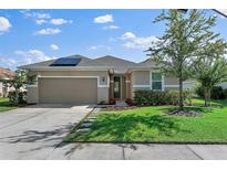 Charming one-story home with a two-car garage and well-manicured lawn at 112 Pergola Pl, Ormond Beach, FL 32174