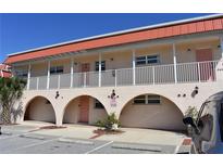 Two-story building with terracotta roof, balconies, and arched entryways at 1510 Ocean Shore Blvd # 4140, Ormond Beach, FL 32176