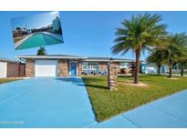 Inviting single-story home with stone facade and landscaped yard at 11 Sunrise Ave, Ormond Beach, FL 32176