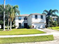 Two story home with a large yard and driveway at 115 Royalty Cir, Sanford, FL 32771