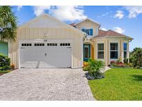 Two-story house with two-car garage, landscaping, and paver driveway at 374 Lost Shaker Way, Daytona Beach, FL 32124