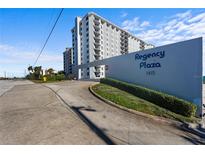 Regency Plaza, 1415: Building exterior view with landscaping and signage at 1415 Ocean Shore Blvd # B030, Ormond Beach, FL 32176