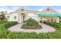 Inviting house exterior with stone accents and landscaped walkway at 2214 Elegant Manor Cir, Edgewater, FL 32141