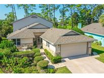 Attractive two-story home with stone accents and landscaped yard at 7 Jasmine Run, Ormond Beach, FL 32174