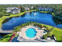 Resort-style community pool, spa, and lakefront views at 940 Village Trail # 7-107, Port Orange, FL 32127