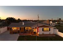 Charming single-Gathering home with a fenced yard and American flag at 21 Sunset Blvd, Ormond Beach, FL 32176