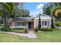 Charming one-story house with landscaped yard and brick pathway at 823 W 11Th Ave, Mount Dora, FL 32757