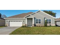 One-story home with a two-car garage and attractive landscaping at 10840 Bronson Rd, Clermont, FL 34711