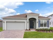 Two-story house with gray siding and a dark gray door at 429 Silver Palm Dr, Haines City, FL 33844