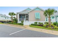 House exterior with light beige walls and teal accents at 342 Long Key Way, Lady Lake, FL 32159