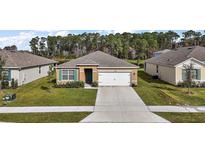 Single story home with two-car garage and landscaped yard at 2720 Dumont Ln, Tavares, FL 32778