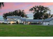 Two story home on a waterfront lot with expansive lawn at 12730 E Highway 25, Ocklawaha, FL 32179