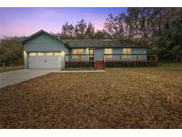 Charming ranch home with a two-car garage and a wood deck at 21342 S Buckhill Rd, Clermont, FL 34715