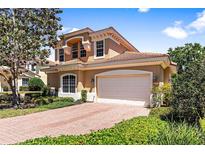 Two story home with brick driveway and lush landscaping at 26142 Avenida Las Colinas # 2B, Howey In The Hills, FL 34737