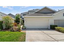 House exterior with attached garage and landscaping at 122 Baytree Blvd, Tavares, FL 32778