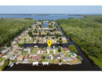 Aerial view of waterfront home in a residential neighborhood at 26637 Bermuda Dr, Tavares, FL 32778