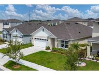 One-story home with two-car garage and lawn at 2705 Lilyturf Ct, Tavares, FL 32778