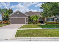 Beautiful two-story home with a stone facade and lush landscaping at 1000 Glenraven Ln, Clermont, FL 34711