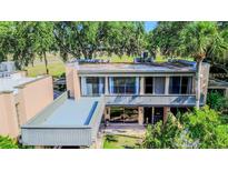 Condo building showcasing a private balcony and lush greenery at 601 W Old Hwy 441 # 11B, Mount Dora, FL 32757