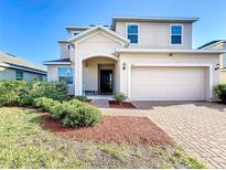 Two-story home with a two-car garage and manicured landscaping at 172 Seville Dr, Davenport, FL 33837
