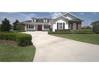 Two-story home with brick and white siding at 6514 Crews Lake Crest Loop, Lakeland, FL 33813