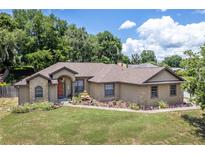 One-story home with stone accents and landscaped yard at 3011 Indian Trl, Eustis, FL 32726