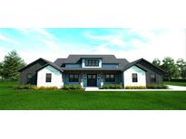 Stunning two-story farmhouse with stone and blue siding, welcoming front porch at 10739 Fiesta St, Clermont, FL 34711