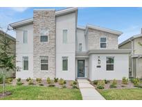Modern two-story home with stone accents at 4189 Paragraph Dr, Kissimmee, FL 34746