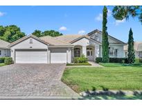 House exterior with double garage and manicured lawn at 3914 Scarborough Ct, Clermont, FL 34711
