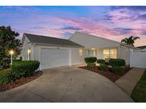 Well-maintained house with a two-car garage and landscaped front yard at 2484 Yalaha Ave, The Villages, FL 32162