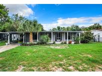 Single-story home with covered porch and lush lawn at 34035 Linda Ln, Leesburg, FL 34788