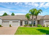Two-car garage and lush landscaping at 3603 Solana Cir # B, Clermont, FL 34711