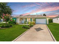 Charming single-story house with a well-manicured lawn and driveway at 8084 Se 175Th Malmaison St, The Villages, FL 32162