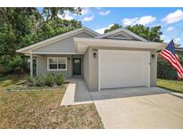 Newly built home with gray siding and white garage door at 500 E Lakeview Ave, Eustis, FL 32726