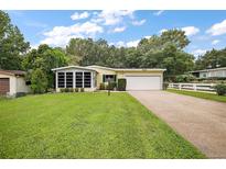 Charming single-story home with attached garage and lush lawn at 25043 Bellevue, Leesburg, FL 34748