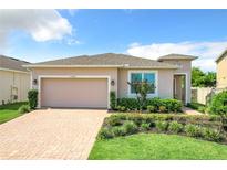 Two-story house with a two-car garage and landscaped yard at 17106 Gathering Place Cir, Clermont, FL 34711