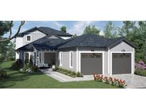 Two-story home with gray siding, two-car garage, and landscaping at 576 Casey Loop, Mount Dora, FL 32757