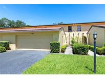 Townhouse exterior with driveway and landscaping at 1111 Lakeshore Dr # A3, Eustis, FL 32726
