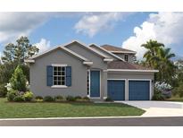 Beautiful two-story home with gray siding and blue garage doors at 86 Spaderdock Ln, Apopka, FL 32712