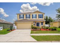 Two-story house with landscaping and driveway at 170 Prairie Falcon Dr, Groveland, FL 34736