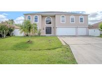 Two-story house with a two-car garage and well-manicured lawn at 1340 Banbridge Dr, Kissimmee, FL 34758