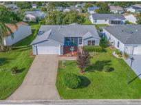 Aerial view of a single-Gathering home with a nicely landscaped yard at 3330 Reston Dr, The Villages, FL 32162